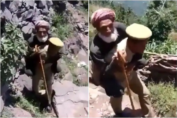 পাহাড়ের ওপরে ভ্যাকসিন কেন্দ্র, বৃদ্ধকে কাঁধে করে নিয়ে গেলেন পুলিশ